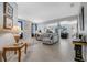 Spacious living room with neutral tones, tile floors, and large windows for natural light creating an airy feel at 16810 Sunrise Vista Dr, Clermont, FL 34714