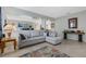 Comfortable living room featuring an L-shaped sofa, a neutral tile floor, and an open concept design at 16810 Sunrise Vista Dr, Clermont, FL 34714
