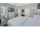 Serene main bedroom with a white duvet, a TV, and ensuite bathroom access creating a peaceful retreat at 16810 Sunrise Vista Dr, Clermont, FL 34714