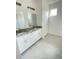 Elegant bathroom with double vanities and granite countertops, and a large closet at 1734 Sail Ct, Kissimmee, FL 34759