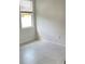 Bright and airy bedroom with tile floors and a large window at 1734 Sail Ct, Kissimmee, FL 34759