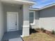Close up of the front entrance showing a white door and manicured garden bed at 1734 Sail Ct, Kissimmee, FL 34759