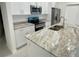 Modern kitchen featuring granite countertops, stainless steel appliances, and ample cabinet space at 1734 Sail Ct, Kissimmee, FL 34759