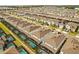 Overhead view of a neighborhood with similar homes featuring backyard pools, screened patios, and sidewalks at 2036 Lelani Cir, Davenport, FL 33897
