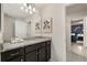 Stylish bathroom with double sink, granite countertop, and modern fixtures for a luxurious feel at 2036 Lelani Cir, Davenport, FL 33897