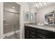 Bathroom featuring a glass-enclosed shower, granite vanity with double sinks and a large mirror at 2036 Lelani Cir, Davenport, FL 33897