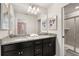 Modern bathroom with a dual-sink vanity, granite countertop, and glass-enclosed shower at 2036 Lelani Cir, Davenport, FL 33897