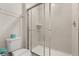 Clean bathroom featuring a toilet, shower, and tiled walls at 2036 Lelani Cir, Davenport, FL 33897