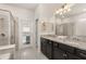 Bathroom featuring a large granite-topped vanity and glass-doored shower at 2036 Lelani Cir, Davenport, FL 33897