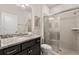 Neutral-toned bathroom featuring granite countertops and a glass-enclosed shower at 2036 Lelani Cir, Davenport, FL 33897