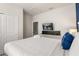 This bedroom features a queen bed, a mounted TV and ensuite bathroom at 2036 Lelani Cir, Davenport, FL 33897