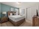Cozy bedroom featuring warm tones, closet, and a comfortable bed with plush pillows at 2036 Lelani Cir, Davenport, FL 33897