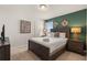 Comfortable bedroom with wood furnishings and an accent wall, perfect for relaxation at 2036 Lelani Cir, Davenport, FL 33897