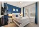 Bright bedroom featuring a queen bed, TV, and ample natural light from the two windows at 2036 Lelani Cir, Davenport, FL 33897