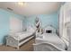 Charming bedroom featuring twin beds, playful mural, and ample natural light at 2036 Lelani Cir, Davenport, FL 33897