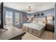 Cozy bedroom featuring a large bed, dresser, and natural light from the windows at 2036 Lelani Cir, Davenport, FL 33897