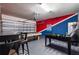 Spacious game room with a pool table, foosball table, and Star Wars themed wall art at 2036 Lelani Cir, Davenport, FL 33897