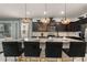 Modern kitchen with granite countertops, stainless steel appliances, dark cabinets, and stylish pendant lighting at 2036 Lelani Cir, Davenport, FL 33897