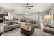 A welcoming living room featuring comfortable sofas, a wooden coffee table, and seamless access to dining area at 2036 Lelani Cir, Davenport, FL 33897