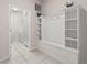 Mudroom with built-in storage, bench, and easy access to the laundry room at 2036 Lelani Cir, Davenport, FL 33897