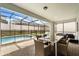 Inviting screened patio features a dining table and seating next to a sparkling pool and hot tub at 2036 Lelani Cir, Davenport, FL 33897