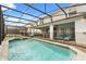 Sparkling pool and spa with screened enclosure and comfortable lounge chairs at 2036 Lelani Cir, Davenport, FL 33897