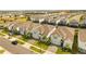 Street view of new homes with light blue exteriors, neat landscaping, and paved driveways at 2036 Lelani Cir, Davenport, FL 33897
