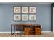 Upstairs, a modern desk with wooden drawers stands out against a backdrop of stylish wall art for remote work at 2036 Lelani Cir, Davenport, FL 33897