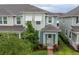 Birds eye view of townhome featuring shutters, lovely landscaping, and a covered porch at 2214 Centerra Loop, Kissimmee, FL 34741