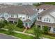 Aerial view of the townhome showcasing its location within a well-maintained neighborhood with mature trees at 2214 Centerra Loop, Kissimmee, FL 34741