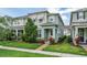 Well-kept two-story townhome featuring an inviting entrance, lush landscaping, and a manicured front lawn at 2214 Centerra Loop, Kissimmee, FL 34741