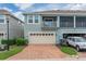 Charming townhome with a brick-paved driveway and a beautiful screened-in balcony on the second story at 2214 Centerra Loop, Kissimmee, FL 34741