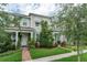 Charming two-story townhome with well-manicured lawn and landscaping, creating a welcoming curb appeal at 2214 Centerra Loop, Kissimmee, FL 34741