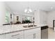 Open-concept kitchen featuring granite countertops that overlook the living room area at 2214 Centerra Loop, Kissimmee, FL 34741