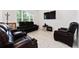 Spacious living room featuring contemporary leather furnishings and recessed lighting at 2214 Centerra Loop, Kissimmee, FL 34741