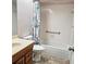 Clean bathroom featuring white tile walls, neutral flooring, and a shower and tub combo at 240 Windmeadows St # 240, Altamonte Springs, FL 32701