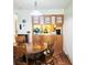 Charming dining room featuring a wooden table set with an adjacent view into the kitchen at 240 Windmeadows St # 240, Altamonte Springs, FL 32701