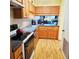 Functional kitchen with wood cabinets, laminate countertops, and essential appliances for meal preparation at 240 Windmeadows St # 240, Altamonte Springs, FL 32701