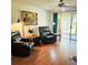 Inviting living room with hardwood floors, dual reclining chairs, and sliding glass doors to the outdoor space at 240 Windmeadows St # 240, Altamonte Springs, FL 32701
