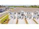 Aerial view of modern townhomes with well-maintained lawns and private driveways at 2413 Brook Marsh Loop, Kissimmee, FL 34747