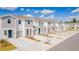 Aerial view of new townhomes showing garages, landscaping, and community layout at 2413 Brook Marsh Loop, Kissimmee, FL 34747