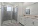 Stylish bathroom features a glass-enclosed shower and a double vanity with storage at 2413 Brook Marsh Loop, Kissimmee, FL 34747