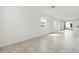 Bright living room with neutral walls, tile flooring, large windows and sliding glass doors to the backyard at 2413 Brook Marsh Loop, Kissimmee, FL 34747