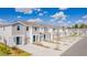 New townhomes featuring neutral color schemes, individual garages, and well-maintained landscaping at 2413 Brook Marsh Loop, Kissimmee, FL 34747