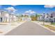 Townhome exteriors with a view down the street showcasing the community's modern design and landscaping at 2413 Brook Marsh Loop, Kissimmee, FL 34747