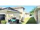 Home backyard with lake view, lush grass, and an air conditioning unit at 2445 Cypress Trace Cir, Orlando, FL 32825