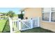 Home's backyard shows a white picket fence and lush green grass, close to neighborhood pond at 2445 Cypress Trace Cir, Orlando, FL 32825