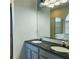 Bathroom featuring double sinks, dark countertops and a large mirror, plus tub and shower at 2445 Cypress Trace Cir, Orlando, FL 32825