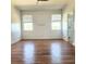 Spacious bedroom with hardwood floors, two windows, and neutral color palette for versatile styling at 2445 Cypress Trace Cir, Orlando, FL 32825