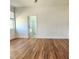 Open Primary bedroom with hardwood flooring and ensuite bathroom entrance at 2445 Cypress Trace Cir, Orlando, FL 32825